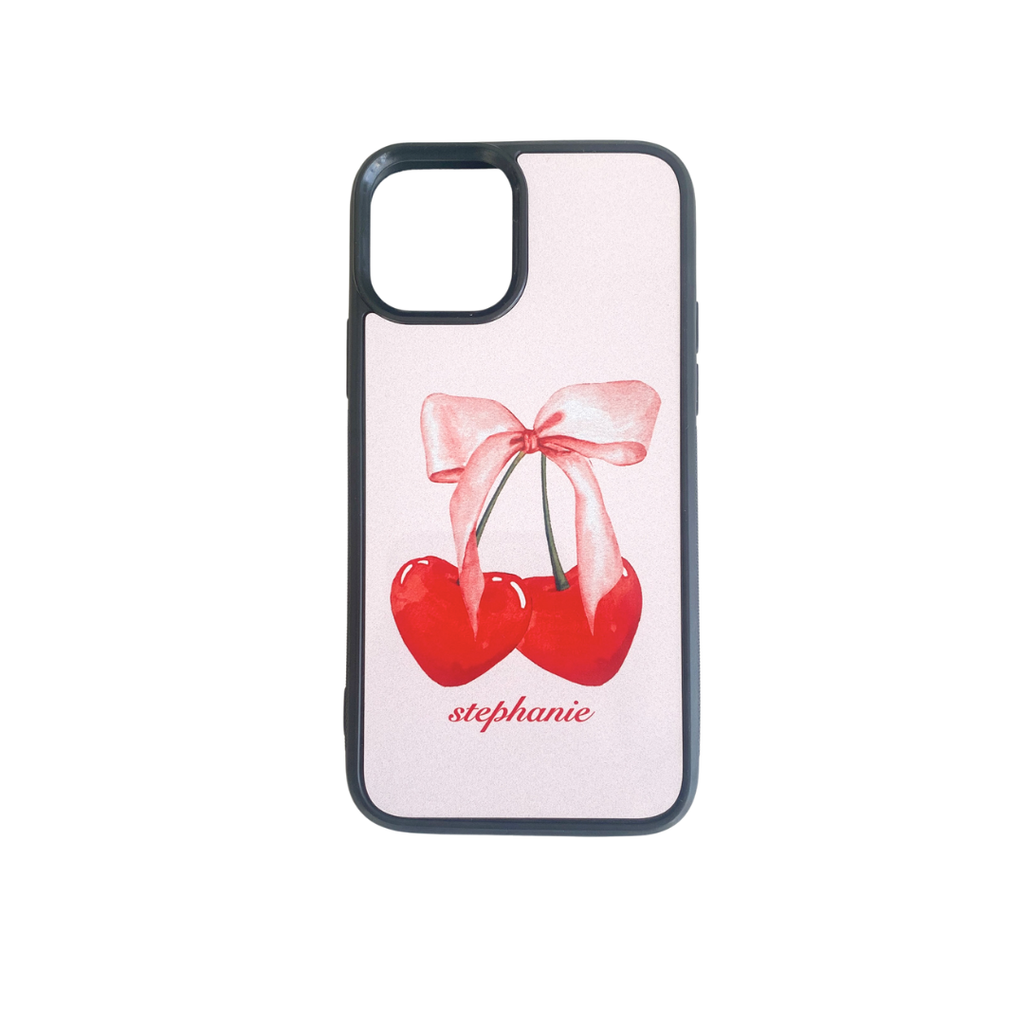 Phone case with cherries and a bow design on a white background