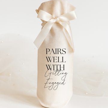 Wine gift bag with 'Pairs Well With Getting Engaged' text on a white background