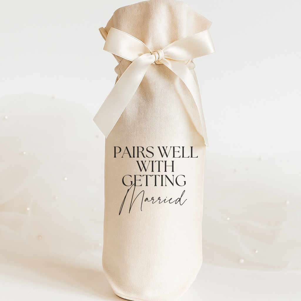 Wine gift bag with a bow and text 'Pairs well with getting married' on a white background